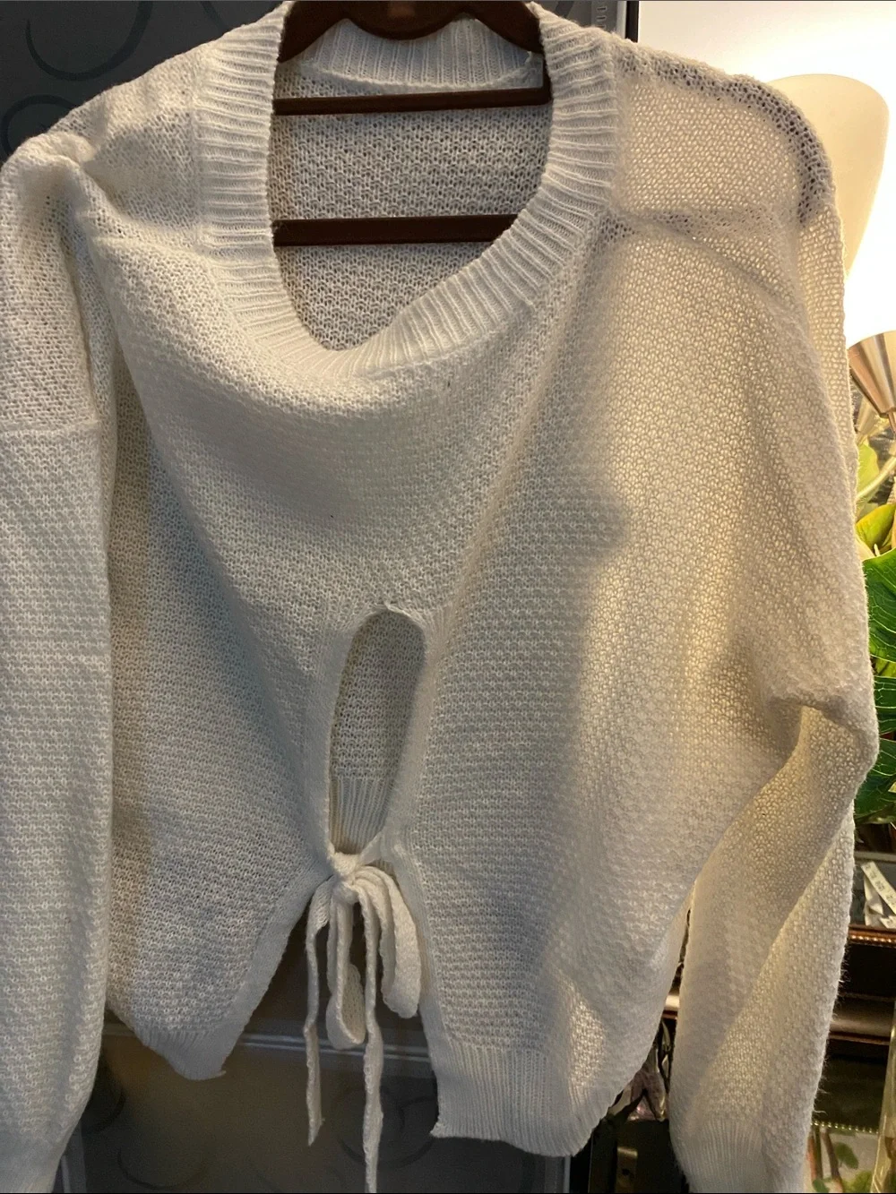 White Women’s Knit Sweater with Tie Details in the Back.